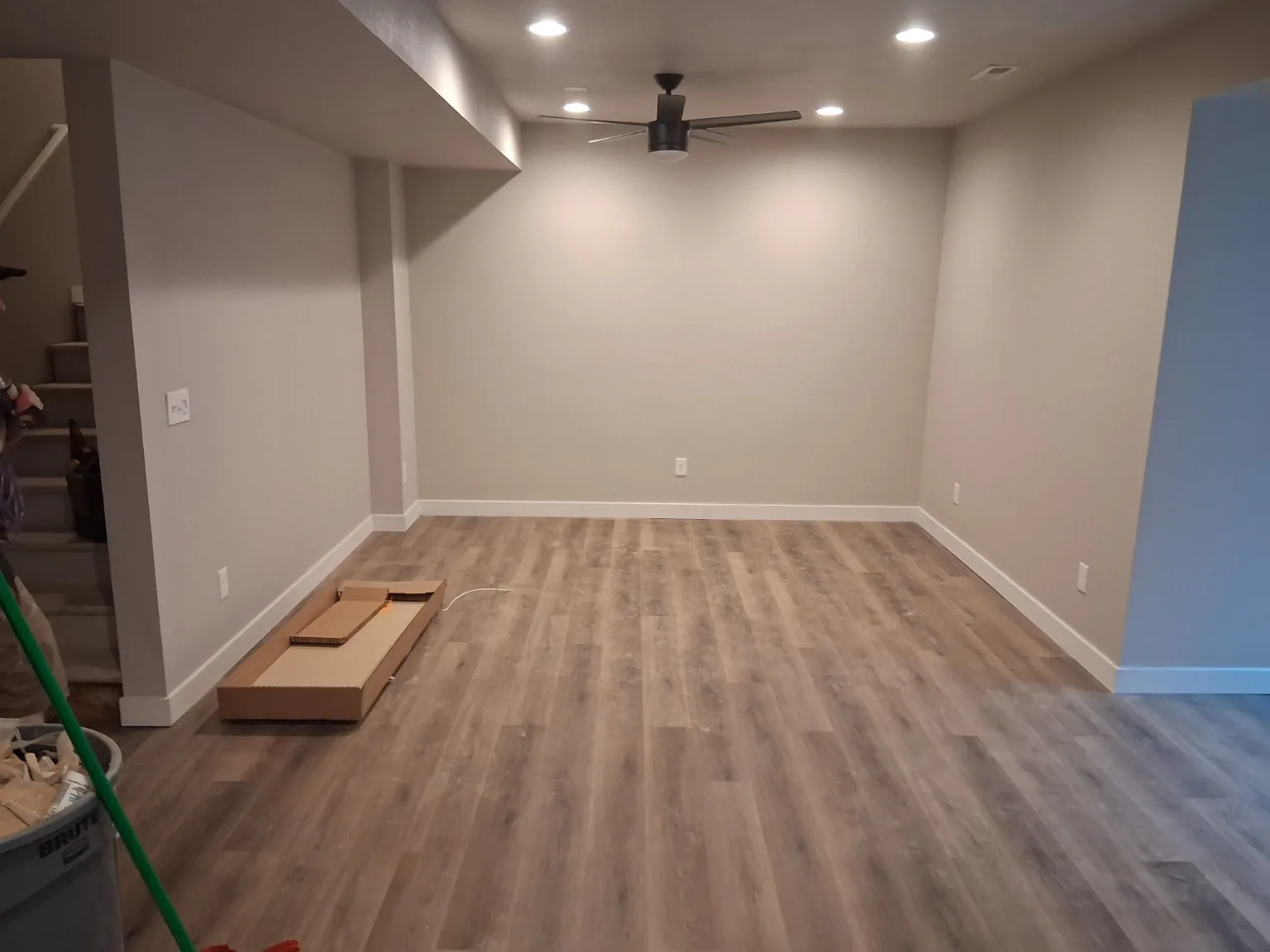 Finished basement LVP flooring with baseboard and trim