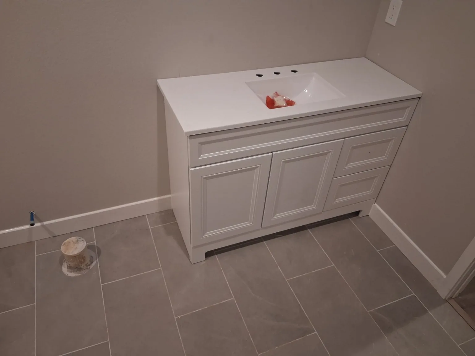 Bathroom vanity set during basement finish work