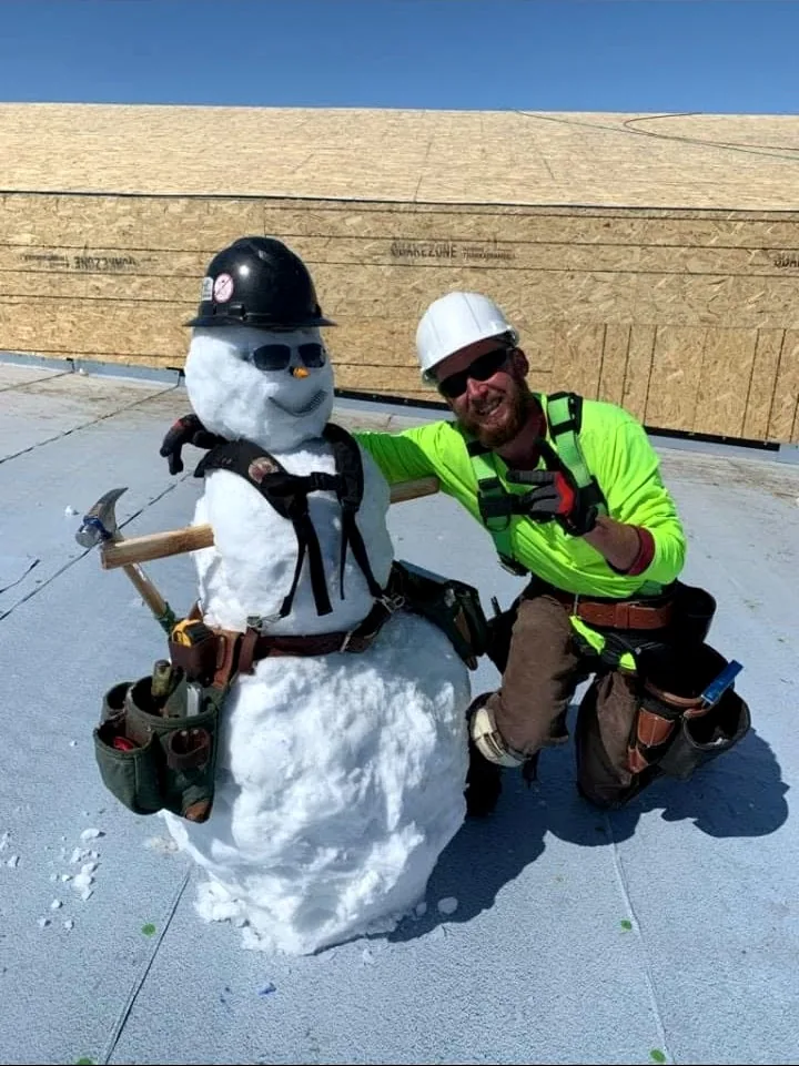 Brady with a jobsite snowman wearing construction gear