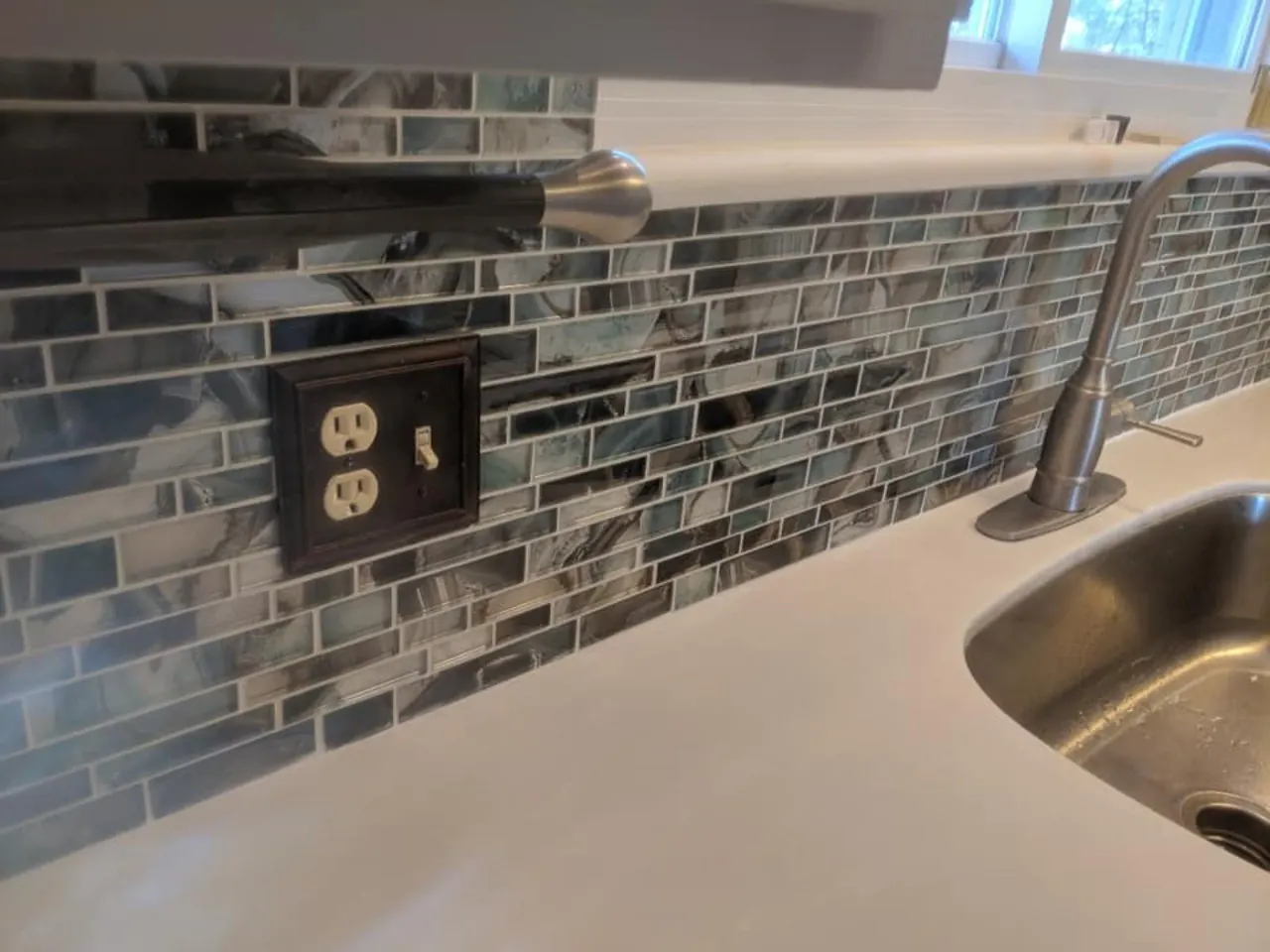 Detailed glass tile backsplash finish work