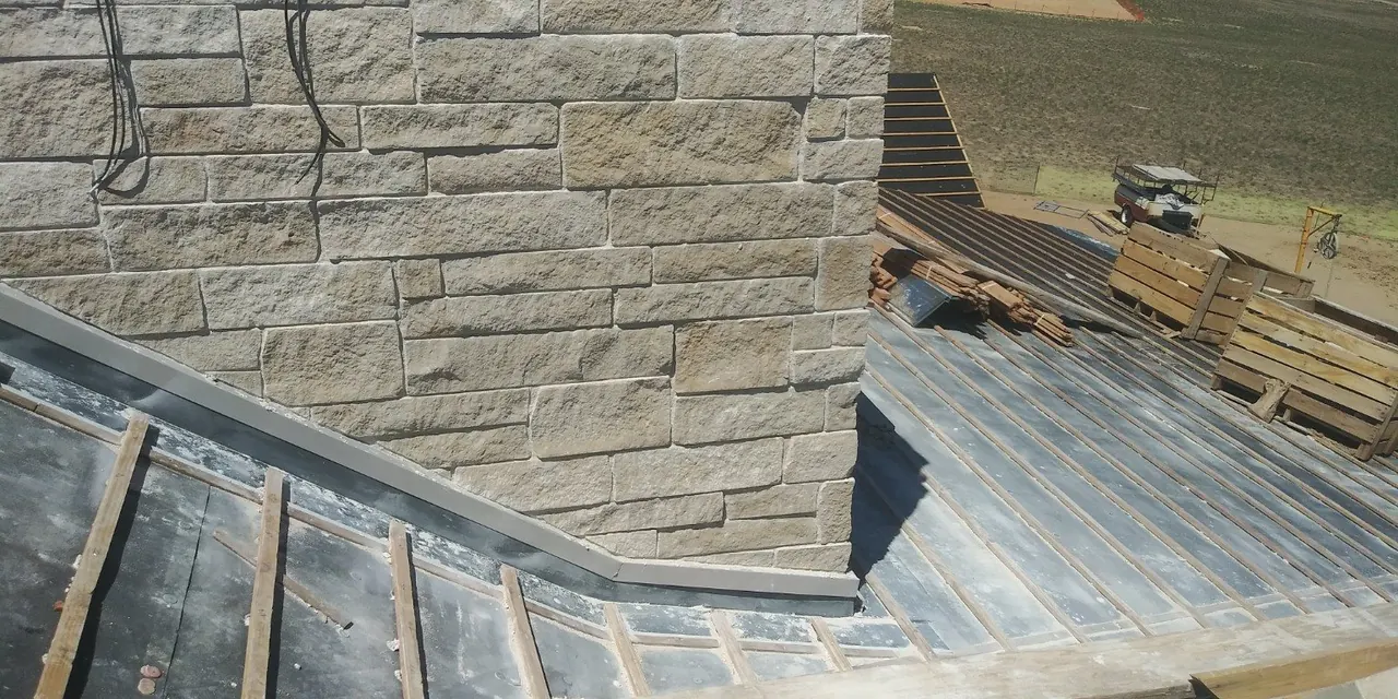 Stone chimney and roof flashing detail