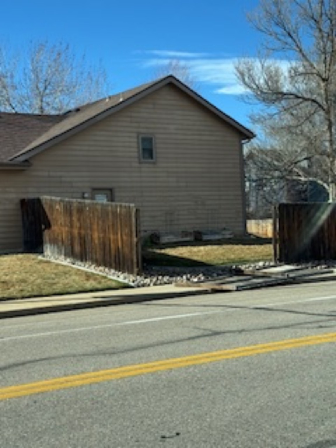 Before fence repair showing failed roadside fence section
