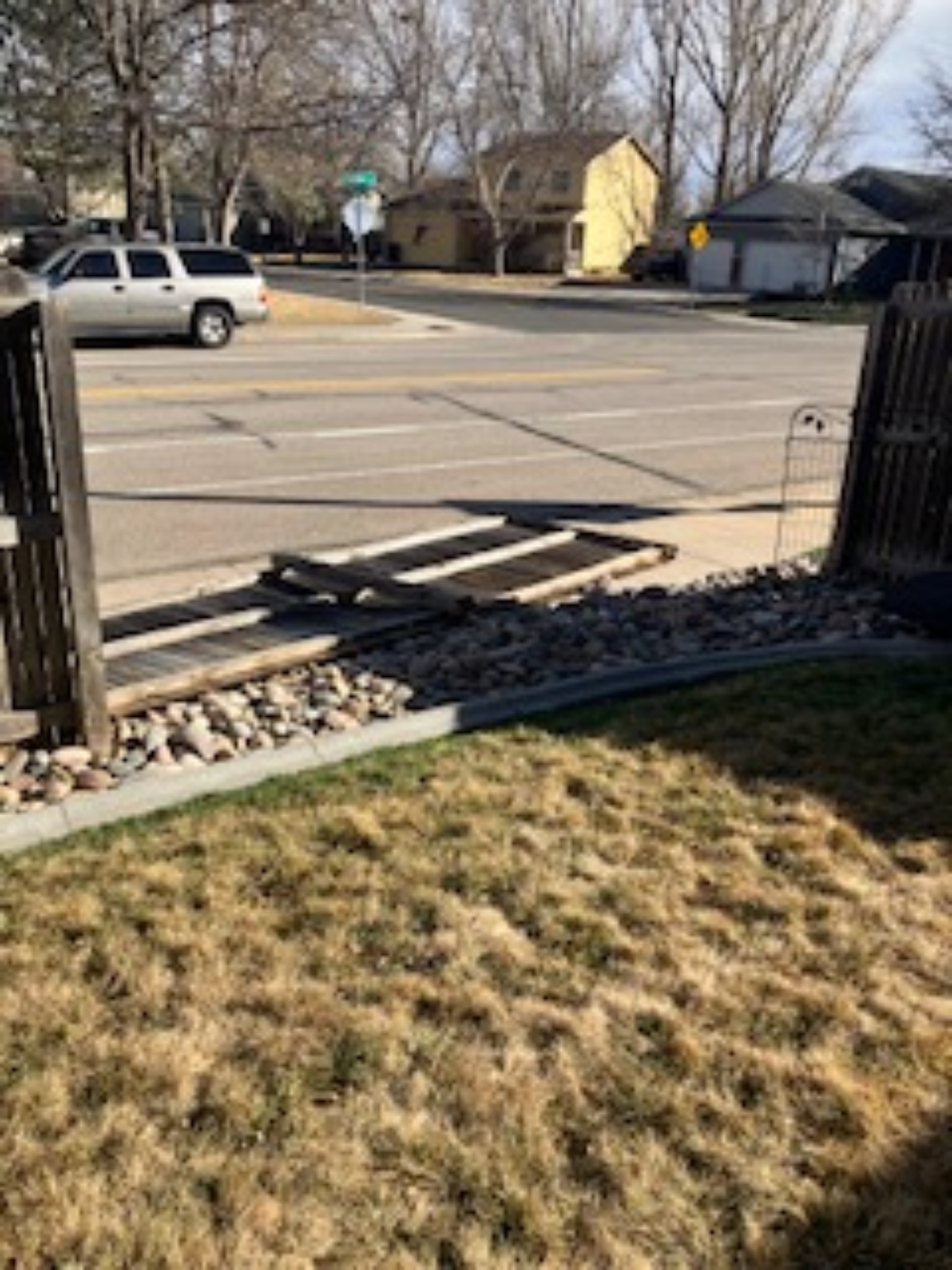 Before fence repair showing collapsed fence opening