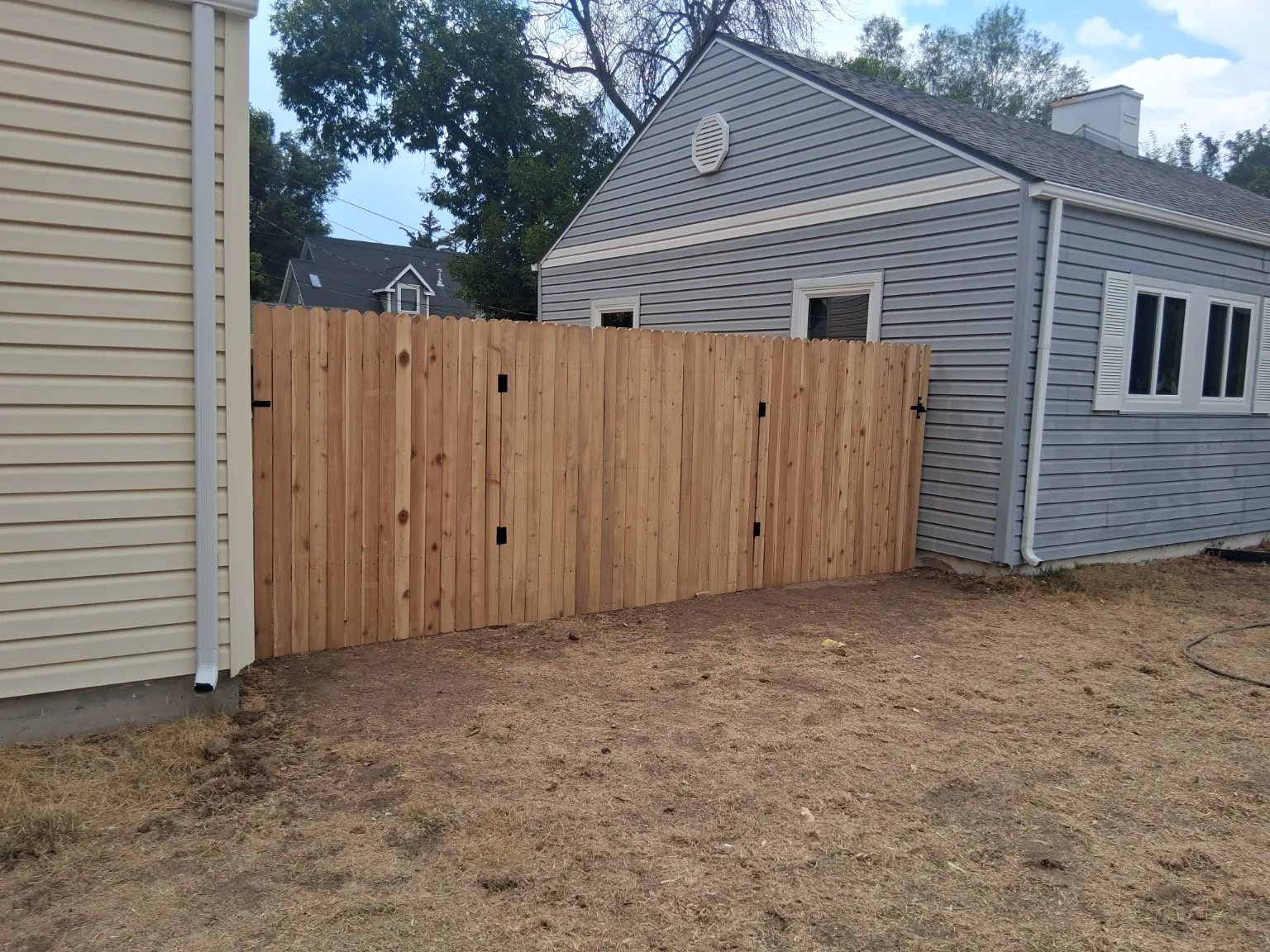 Finished double gate integrated into a cedar privacy fence