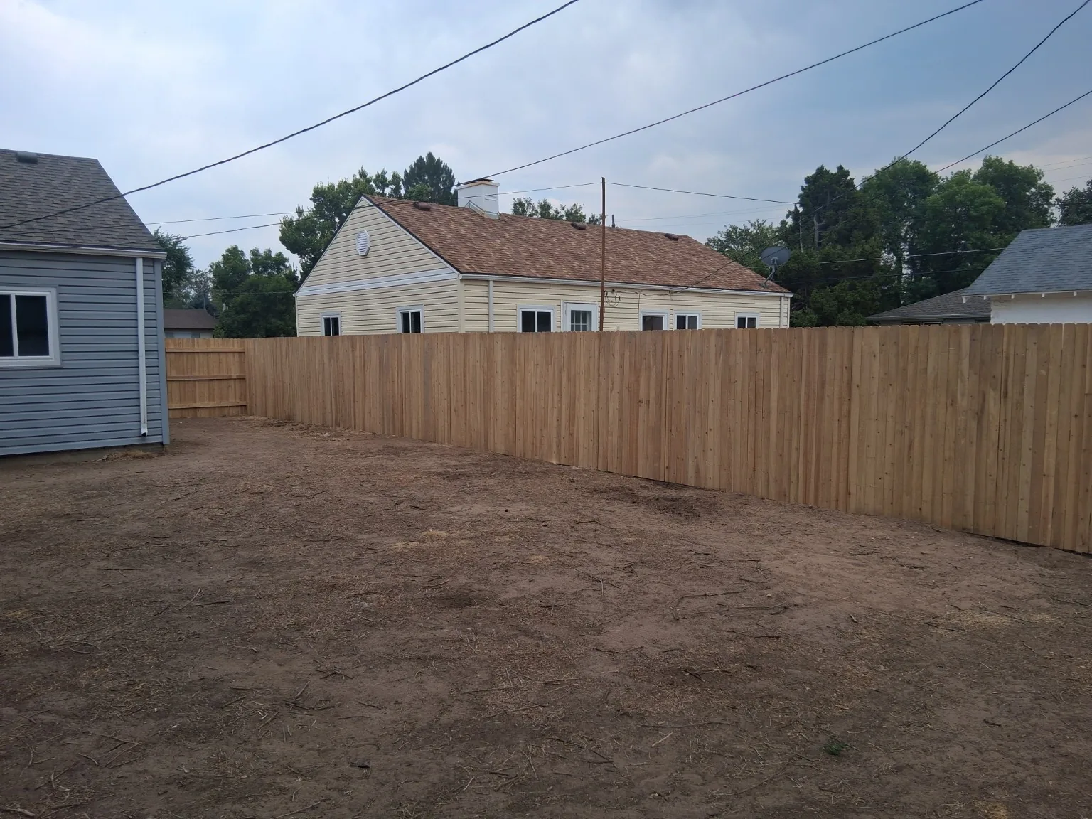 Recent cedar privacy fence installation viewed from the finished yard side